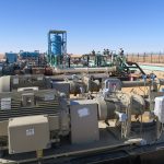 Oil pumping at an early production facility site